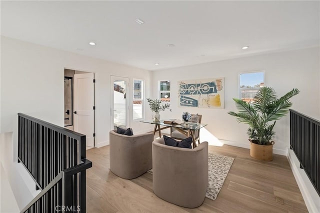 living room featuring light wood finished floors, baseboards, and recessed lighting