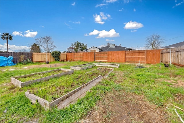 view of yard featuring a fenced backyard and a vegetable garden