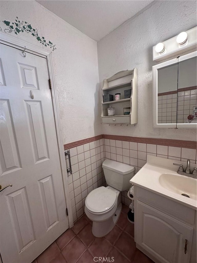 33518 Colorado St, Yucaipa, CA 92399 - half bath with toilet, tile walls, vanity, and tile patterned flooring
