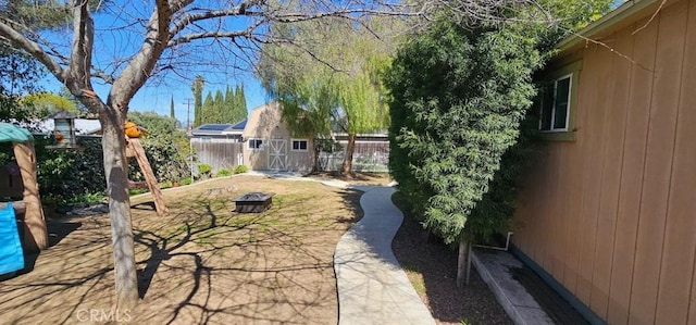 33518 Colorado St, Yucaipa, CA 92399 - view of yard with an outbuilding, a fenced backyard, a shed, and an outdoor fire pit
