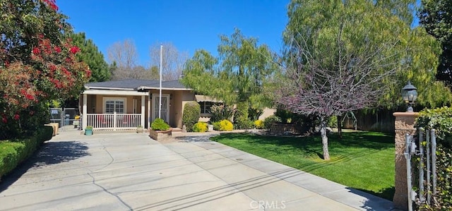 33518 Colorado St, Yucaipa, CA 92399 - ranch-style house featuring a front yard, a porch, fence, and stucco siding