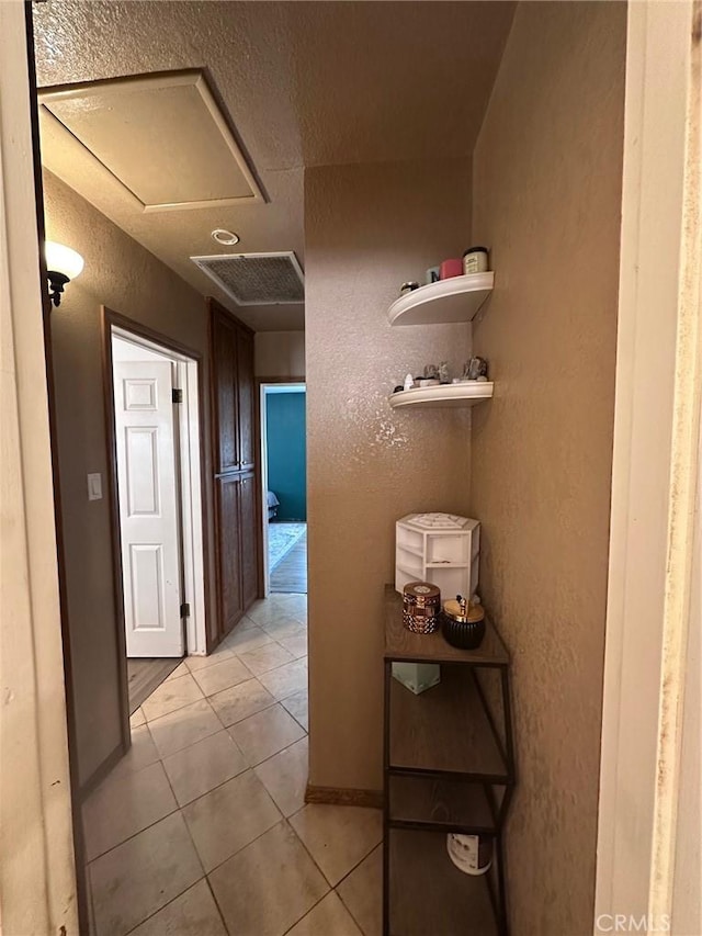 33518 Colorado St, Yucaipa, CA 92399 - hallway with light tile patterned floors, a textured wall, and visible vents