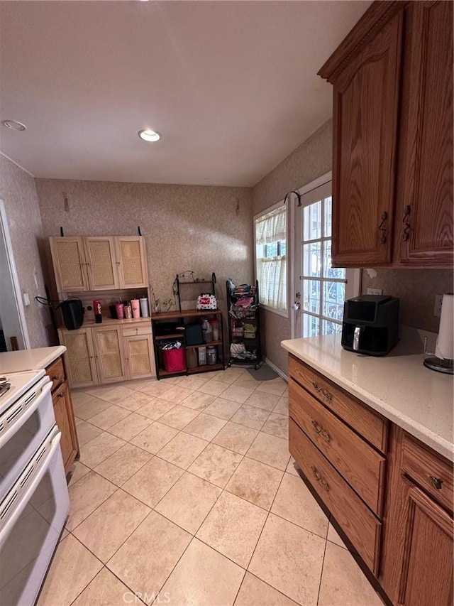 33518 Colorado St, Yucaipa, CA 92399 - kitchen featuring wallpapered walls, light countertops, range with two ovens, light tile patterned floors, and recessed lighting