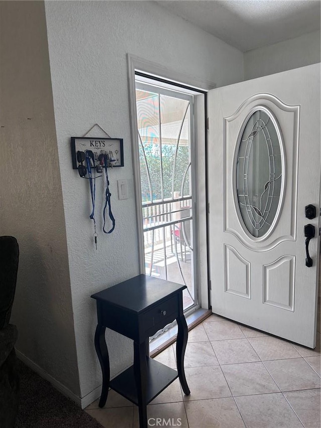 33518 Colorado St, Yucaipa, CA 92399 - entryway with light tile patterned floors, baseboards, and a textured wall