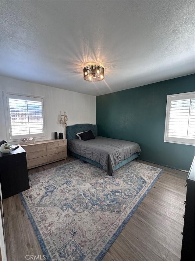 33518 Colorado St, Yucaipa, CA 92399 - bedroom featuring multiple windows, a textured ceiling, and wood finished floors