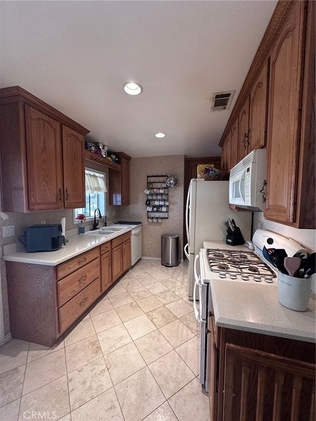 33518 Colorado St, Yucaipa, CA 92399 - kitchen featuring visible vents, a sink, white appliances, light tile patterned flooring, and light countertops