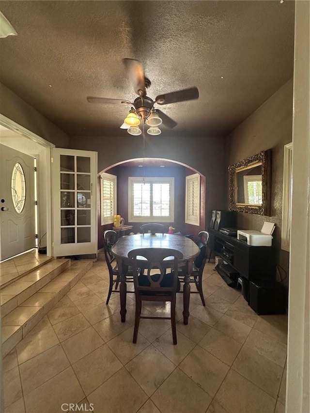 33518 Colorado St, Yucaipa, CA 92399 - tiled dining room featuring a textured ceiling, arched walkways, and ceiling fan