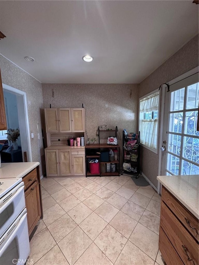 33518 Colorado St, Yucaipa, CA 92399 - kitchen with double oven range, wallpapered walls, light tile patterned floors, baseboards, and light countertops
