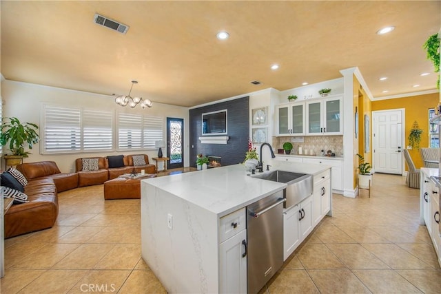 kitchen with dishwasher, light tile patterned floors, a sink, and visible vents