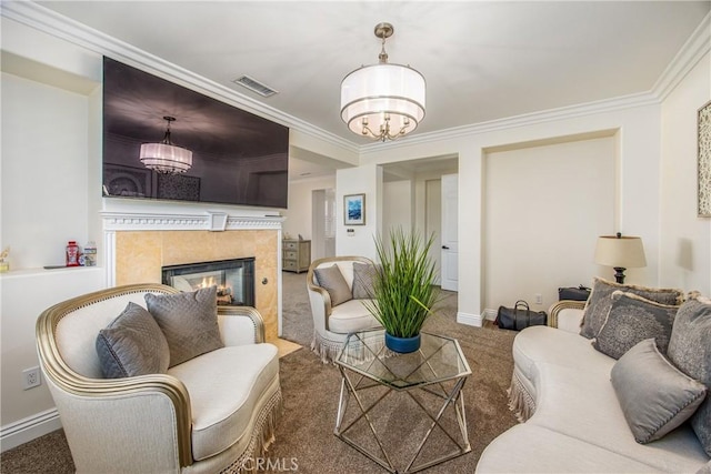 carpeted living room featuring a fireplace, crown molding, visible vents, a chandelier, and baseboards