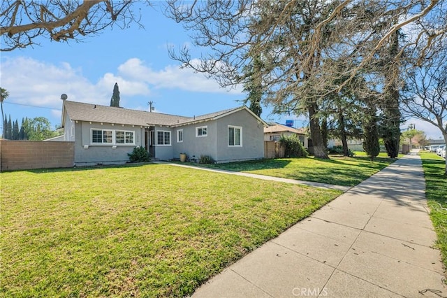 single story home featuring fence, a front lawn, and stucco siding