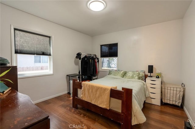 bedroom featuring baseboards and wood finished floors