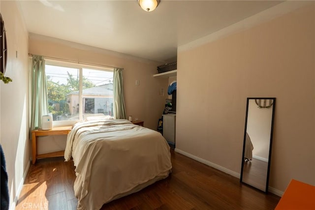 bedroom with baseboards and wood finished floors