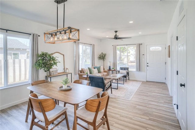 dining room featuring baseboards, recessed lighting, and light wood-style floors