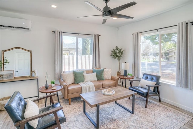 living area with plenty of natural light, light wood finished floors, a wall mounted air conditioner, and recessed lighting