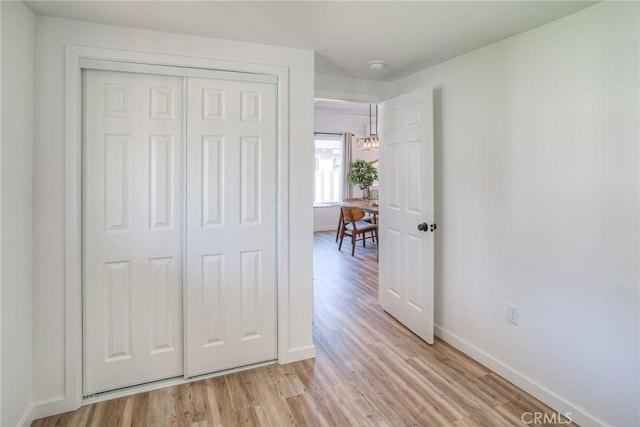 interior space featuring light wood-style floors and baseboards