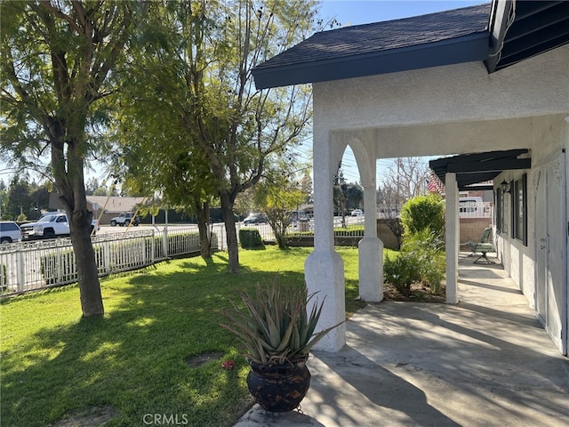 view of yard with fence and a patio