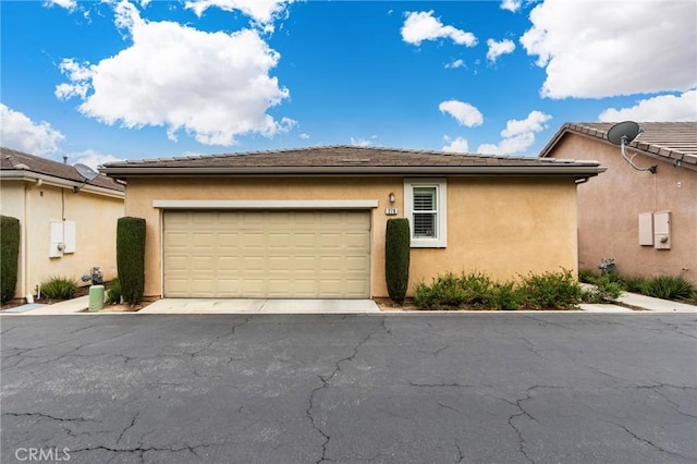 view of home's exterior featuring an attached garage and stucco siding