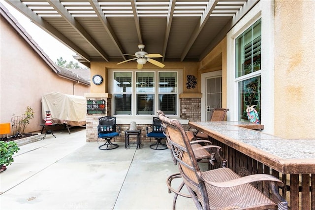 view of patio / terrace featuring ceiling fan, outdoor dry bar, and a pergola