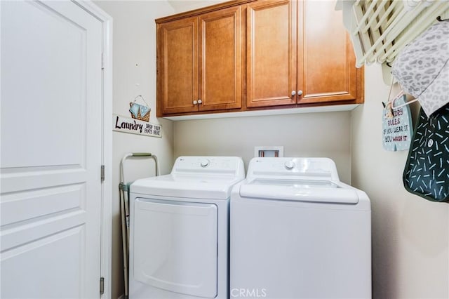 washroom with cabinet space and independent washer and dryer