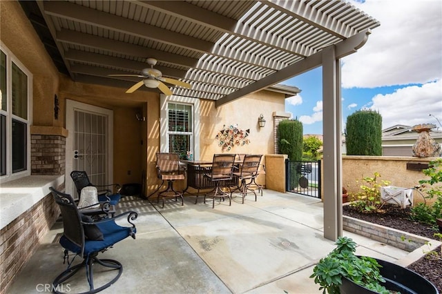 view of patio / terrace featuring outdoor dining space, fence, a ceiling fan, and a pergola