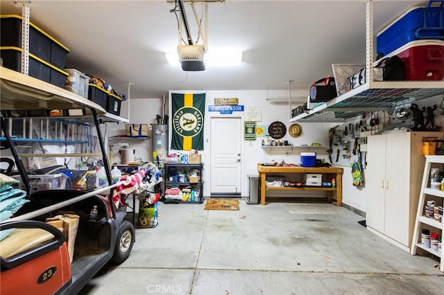 garage with water heater, a workshop area, and a garage door opener