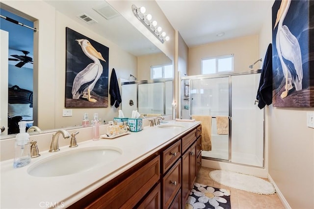 full bath with tile patterned flooring, visible vents, a sink, and a shower stall