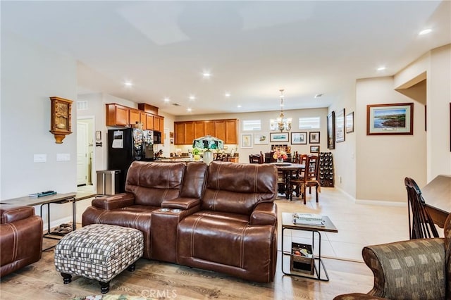 living room with an inviting chandelier, visible vents, baseboards, and recessed lighting