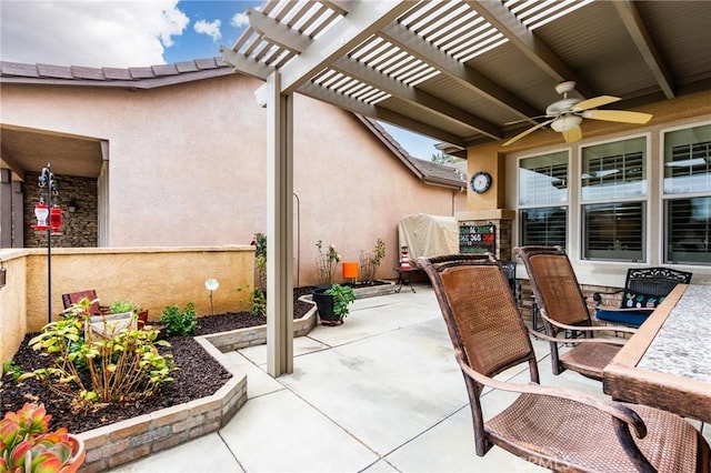 view of patio with a ceiling fan, outdoor dining area, and a pergola