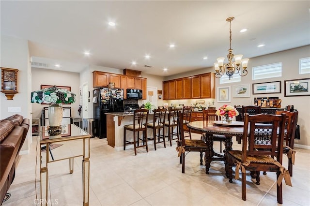 dining room featuring baseboards, visible vents, a notable chandelier, and recessed lighting