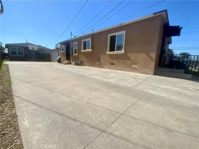 exterior space featuring crawl space and stucco siding