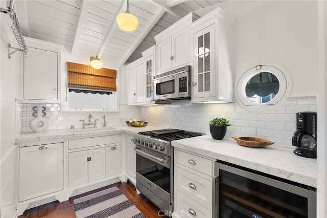 kitchen with wine cooler, stainless steel appliances, a sink, white cabinetry, and glass insert cabinets