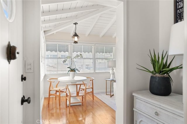 dining room with lofted ceiling with beams, wood finished floors, wood ceiling, and baseboards