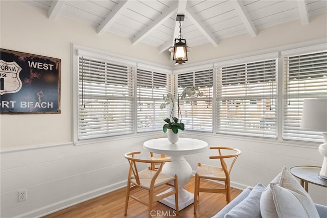 dining area with vaulted ceiling with beams, wooden ceiling, and wood finished floors