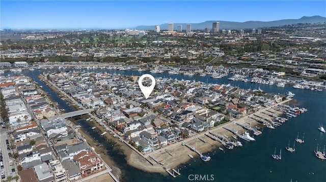 birds eye view of property featuring a view of city and a water and mountain view