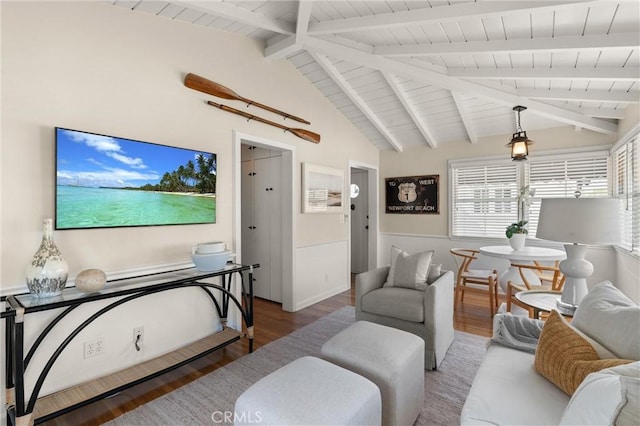 living room with lofted ceiling with beams, a wainscoted wall, and wood finished floors