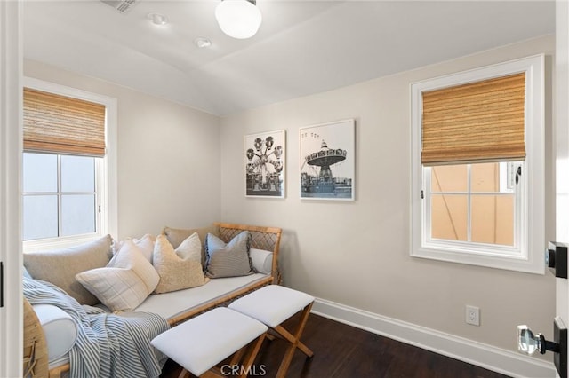 living area featuring baseboards, vaulted ceiling, and dark wood finished floors