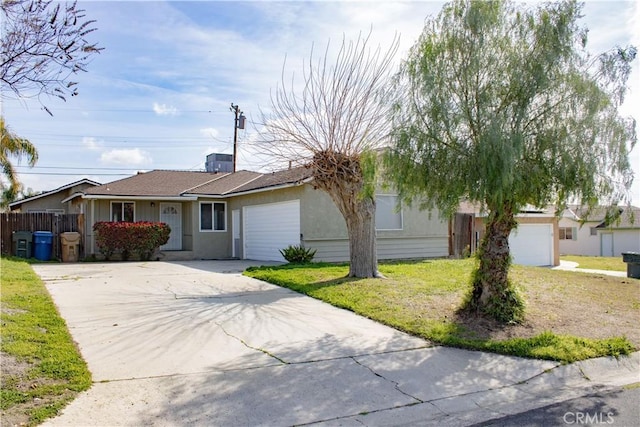 ranch-style house featuring a garage, driveway, a front lawn, and fence