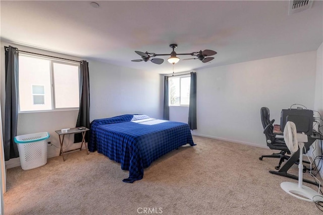 bedroom with visible vents, ceiling fan, light carpet, and baseboards