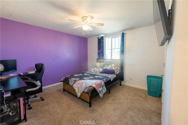 bedroom with light carpet, ceiling fan, and baseboards