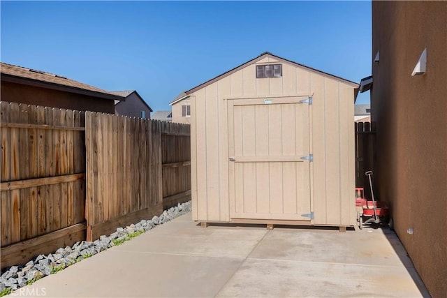 view of shed featuring fence