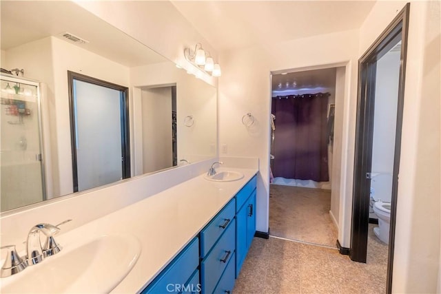 full bathroom featuring visible vents, double vanity, a sink, and toilet