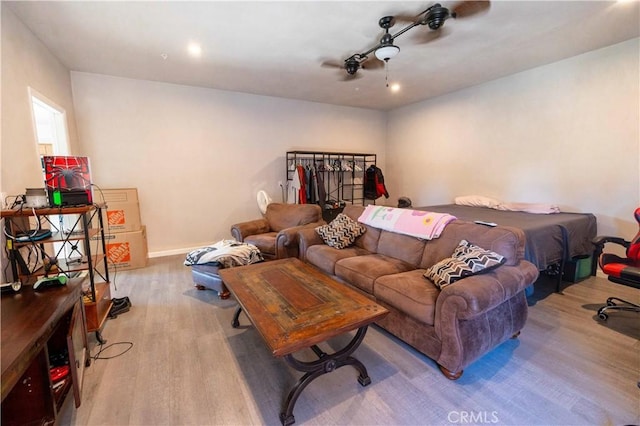 bedroom featuring light wood-type flooring, ceiling fan, and baseboards