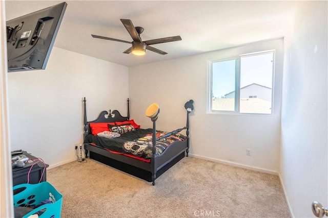 bedroom featuring light carpet, ceiling fan, and baseboards