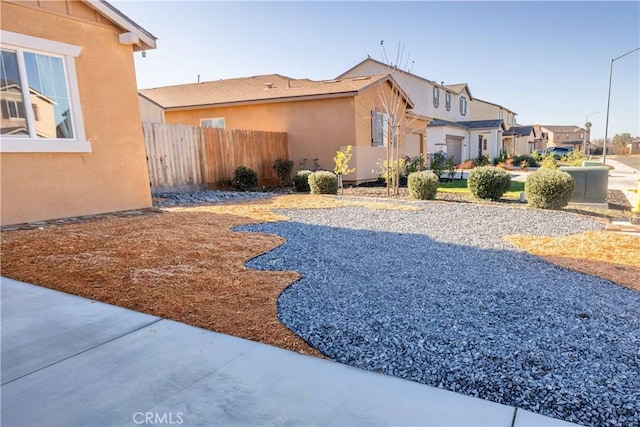 view of yard with a residential view and fence