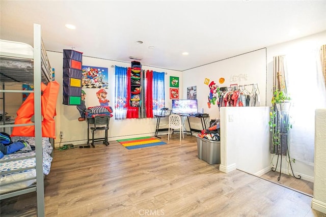 rec room with baseboards, wood finished floors, and recessed lighting