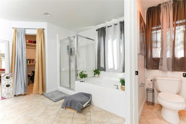 bathroom with toilet, a stall shower, tile patterned flooring, and a bath