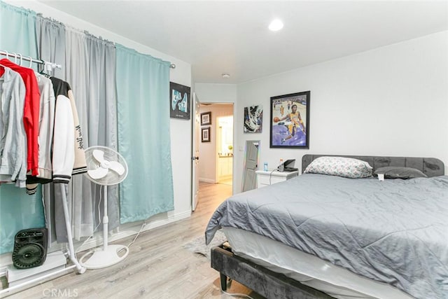 bedroom with wood finished floors and baseboards