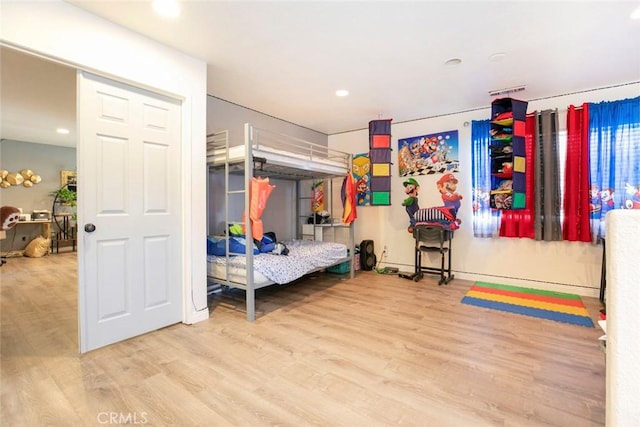 bedroom featuring recessed lighting and wood finished floors