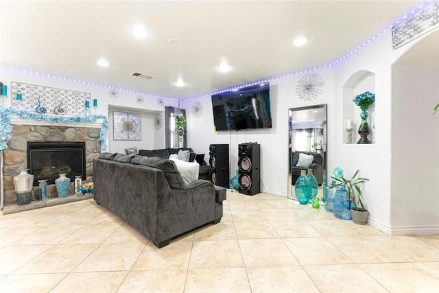 living room with light tile patterned floors, baseboards, visible vents, a fireplace, and recessed lighting